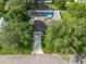 An aerial view of a home with a pool and spacious backyard, surrounded by mature trees at 9364 Se 164Th Pl, Summerfield, FL 34491