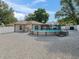 View of the house and backyard featuring a pool, sheds, and a white vinyl fence at 9364 Se 164Th Pl, Summerfield, FL 34491