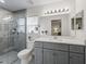 Bathroom features updated gray vanity with white countertop and a glass walk-in shower at 9364 Se 164Th Pl, Summerfield, FL 34491