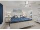 Spacious bedroom features tile floors, neutral walls, a ceiling fan, and lots of natural light at 9364 Se 164Th Pl, Summerfield, FL 34491