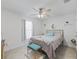 Bedroom with white walls, ceiling fan, comfy bed, and natural light from the window at 9364 Se 164Th Pl, Summerfield, FL 34491