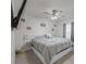 Bedroom with ceiling fan, mounted TV, white headboard with side storage and gray comforter at 9364 Se 164Th Pl, Summerfield, FL 34491