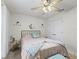Bedroom with comfy bed, white walls, ceiling fan, and natural light from the window at 9364 Se 164Th Pl, Summerfield, FL 34491
