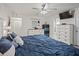 Lovely bedroom with tile floors, TV, ensuite bath access, neutral walls, and ceiling fan at 9364 Se 164Th Pl, Summerfield, FL 34491