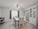 The dining area features light, neutral walls, a window and a lovely table and seating for four at 9364 Se 164Th Pl, Summerfield, FL 34491