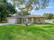 Charming single-story home with a well-maintained lawn, an inviting facade and lush landscaping at 9364 Se 164Th Pl, Summerfield, FL 34491