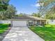 Beautiful single-story home with a manicured lawn, two-car garage, and tasteful landscaping at 9364 Se 164Th Pl, Summerfield, FL 34491