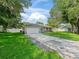 Charming single-story home with well-manicured lawn, long driveway, and an attached two-car garage at 9364 Se 164Th Pl, Summerfield, FL 34491