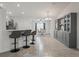 Bright, neutral kitchen area opens to dining and features bar seating and built in bar and glass storage area at 9364 Se 164Th Pl, Summerfield, FL 34491