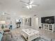 Open-concept living room featuring tile flooring, a large sectional sofa, and access to the kitchen and dining areas at 9364 Se 164Th Pl, Summerfield, FL 34491