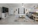 Inviting living room with tiled floors, modern furnishings, an open layout, and plenty of natural light at 9364 Se 164Th Pl, Summerfield, FL 34491