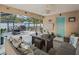 Screened patio with comfortable seating, a dining area, and a view of the pool at 9364 Se 164Th Pl, Summerfield, FL 34491