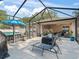 The screened patio includes a dining area and living space overlooking the pool, creating a cozy outdoor retreat at 9364 Se 164Th Pl, Summerfield, FL 34491