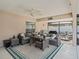 Screened in patio featuring stylish seating, a ceiling fan, and a barbecue grill at 9364 Se 164Th Pl, Summerfield, FL 34491