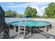 Image shows an above ground pool surrounded by a gravel bed and a white fence at 9364 Se 164Th Pl, Summerfield, FL 34491
