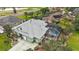 Aerial view of property showcasing lush landscaping, private pool area, and desirable neighborhood setting at 946 Isle Of Palms Path, The Villages, FL 32162