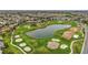 Panoramic aerial view showcasing the golf course, lake, and residential neighborhood at 946 Isle Of Palms Path, The Villages, FL 32162