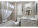 Bathroom features a shower-tub combination, a window with plantation shutters, and a vanity at 946 Isle Of Palms Path, The Villages, FL 32162