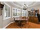 Cozy dining room area featuring hardwood floors, shuttered windows, and chandelier lighting at 946 Isle Of Palms Path, The Villages, FL 32162