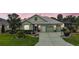 Charming single-story home boasts a well-manicured lawn, mature landscaping, and a three-car garage at 946 Isle Of Palms Path, The Villages, FL 32162