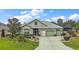 Charming single-story home with a lush green lawn, mature landscaping, and a well-maintained front yard at 946 Isle Of Palms Path, The Villages, FL 32162
