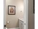 Powder room with marble top vanity and decorative floral painting at 946 Isle Of Palms Path, The Villages, FL 32162