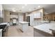 Bright, spacious kitchen features modern white cabinetry, granite countertops and stainless appliances at 946 Isle Of Palms Path, The Villages, FL 32162