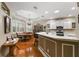 Open kitchen featuring a breakfast bar and adjoined dining area with hardwood floors at 946 Isle Of Palms Path, The Villages, FL 32162