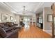 Elegant living room showcasing hardwood floors, recessed lighting and comfortable leather furniture at 946 Isle Of Palms Path, The Villages, FL 32162