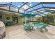 Enjoy outdoor living on this spacious patio with a dining area and comfortable lounge chairs by the pool at 946 Isle Of Palms Path, The Villages, FL 32162