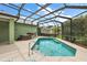 Screened in pool with a hot tub, and ample seating area at 946 Isle Of Palms Path, The Villages, FL 32162