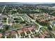 Aerial view of a residential community with lush green landscaping, mature trees, and nearby lake at 10240 Kabana Blvd, Clermont, FL 34711