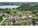 Aerial view of the community with a pond, lush landscaping, and lake in the background at 10240 Kabana Blvd, Clermont, FL 34711