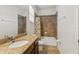 Bathroom featuring a shower-tub combo with tiled walls and granite vanity at 10240 Kabana Blvd, Clermont, FL 34711