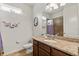 Bathroom with a granite countertop vanity, a sink, and an open shower behind a patterned shower curtain at 10240 Kabana Blvd, Clermont, FL 34711