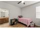 Bright bedroom with wood floors, ceiling fan and ensuite bathroom at 10240 Kabana Blvd, Clermont, FL 34711