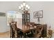 Cozy dining room featuring a dark wood table, chairs, and natural light from an arched window at 10240 Kabana Blvd, Clermont, FL 34711