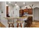 Eat-in kitchen showcasing wood cabinets, granite countertops, and bar stool seating at 10240 Kabana Blvd, Clermont, FL 34711