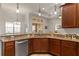 Kitchen with stainless steel dishwasher, granite countertops, and wood cabinets at 10240 Kabana Blvd, Clermont, FL 34711