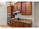 Kitchen with stainless steel appliances, granite countertops, and wood cabinetry at 10240 Kabana Blvd, Clermont, FL 34711