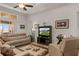 Comfortable living room featuring neutral colors, a ceiling fan, and a large screen television at 10240 Kabana Blvd, Clermont, FL 34711