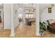 Open-concept living space with tiled floors, columns, and a glimpse into other rooms at 10240 Kabana Blvd, Clermont, FL 34711