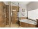 Contemporary bathroom featuring a walk-in shower and a soaking tub near a window that lets in natural light at 10240 Kabana Blvd, Clermont, FL 34711