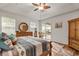 Bright main bedroom with ceiling fan, backyard views and wooden furniture at 10240 Kabana Blvd, Clermont, FL 34711