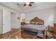 Warm main bedroom with wooden furniture, ceiling fan, and ensuite bathroom at 10240 Kabana Blvd, Clermont, FL 34711