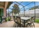 Covered patio with dining set and outdoor grill perfect for entertaining at 10240 Kabana Blvd, Clermont, FL 34711