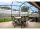 Screened-in patio featuring a dining table and hot tub at 10240 Kabana Blvd, Clermont, FL 34711