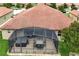 Enclosed patio with outdoor furniture, featuring a hot tub and dining set for relaxation and entertainment at 10240 Kabana Blvd, Clermont, FL 34711