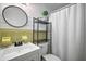 Charming bathroom with a round mirror, white vanity, and bright yellow and white accents at 10303 Se Sunset Harbor Rd, Summerfield, FL 34491