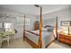 Bedroom featuring wood-framed bed, vanity, dresser, and windows at 10303 Se Sunset Harbor Rd, Summerfield, FL 34491